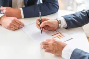 two businessman analyzing the business report