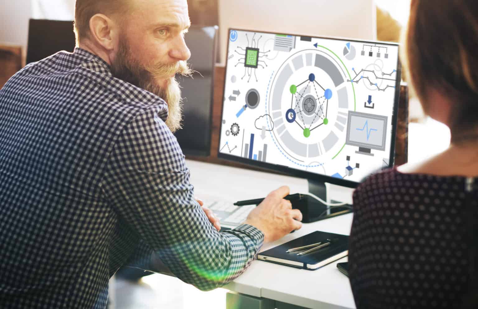 Man working on computer with grapthics shown on his screen