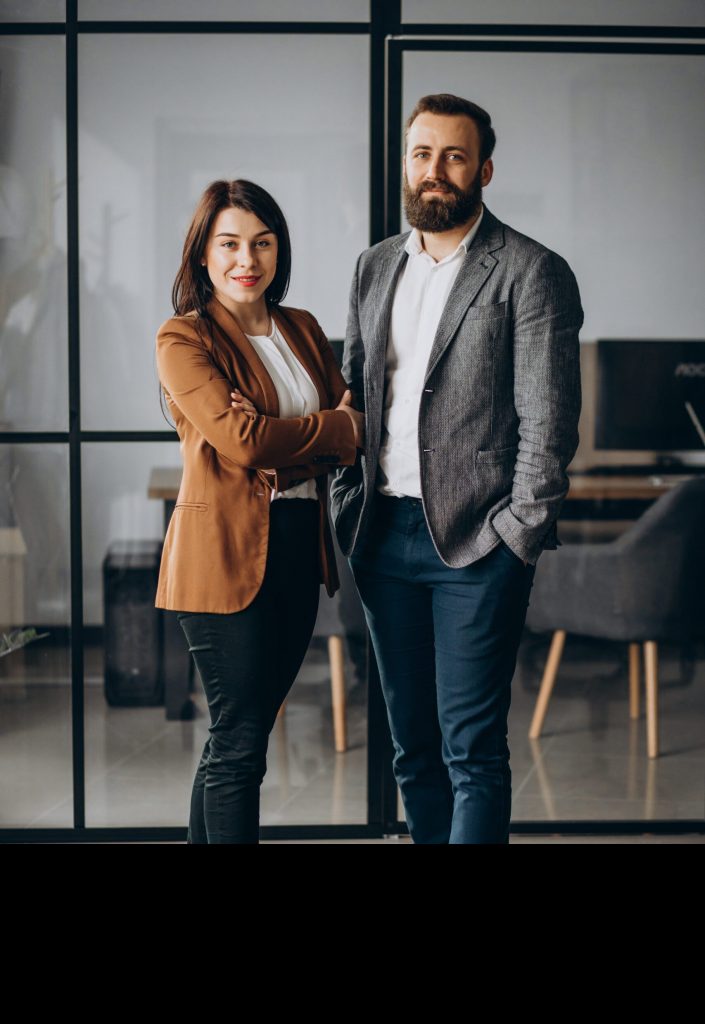 Two COOs, woman and man, standing next to each other in office